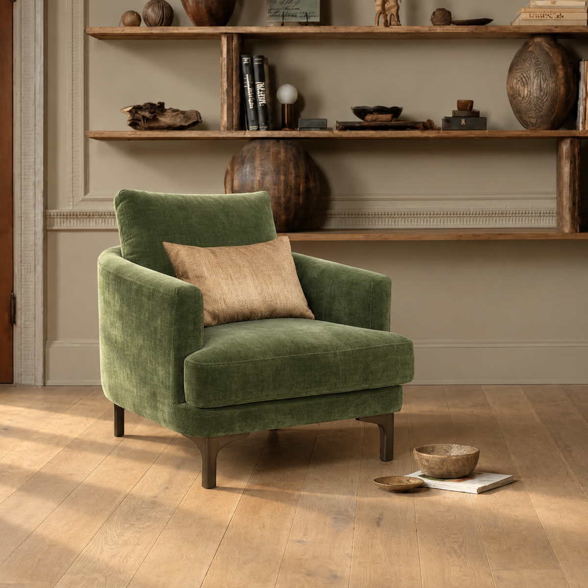 Green velvet Florence armchair styled in a living room with wooden shelving and decorative objects