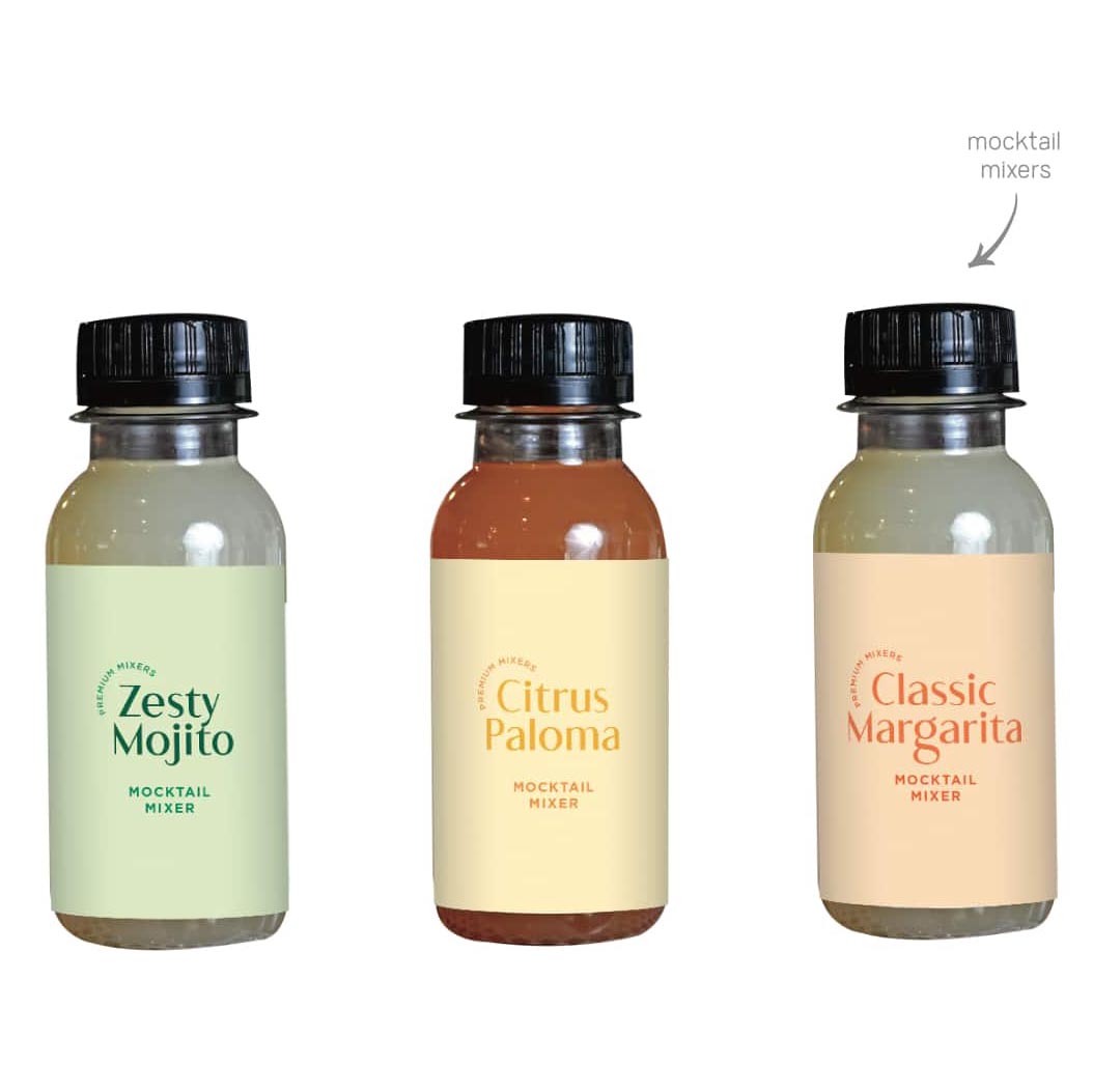 Side-by-side view of three mocktail mixer bottles with black screw caps and simple labels.