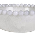 Close-up of the smooth bobble-edge rim and glossy white resin texture on the display bowl