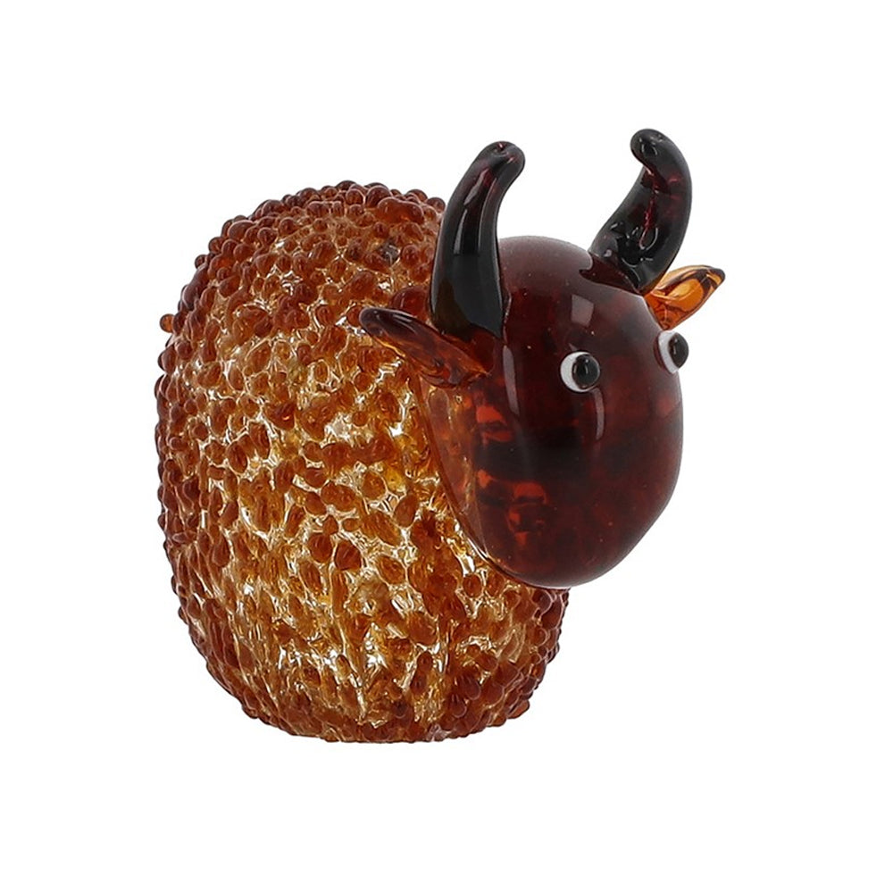 Side profile of a handmade glass Highland cow ornament against a plain white background.