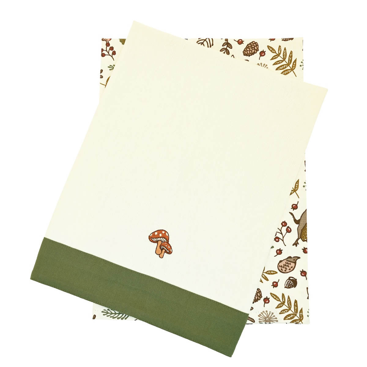 Into the Woods tea towel set showing one forest print towel and one cream towel with embroidered toadstools.