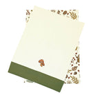 Into the Woods tea towel set showing one forest print towel and one cream towel with embroidered toadstools.