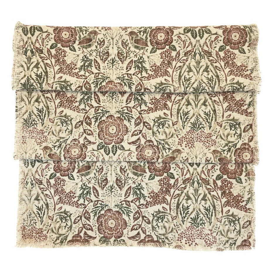 Jenny Wren table runner showing the bird and floral print in brown and green tones on a cream slub fabric.