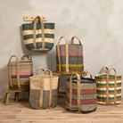 A collection of various striped jute storage baskets in different earthy colours styled in a room setting.