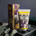Close-up of the Kew Gardens hand cream tube and gift box styled on a tray with eucalyptus leaves