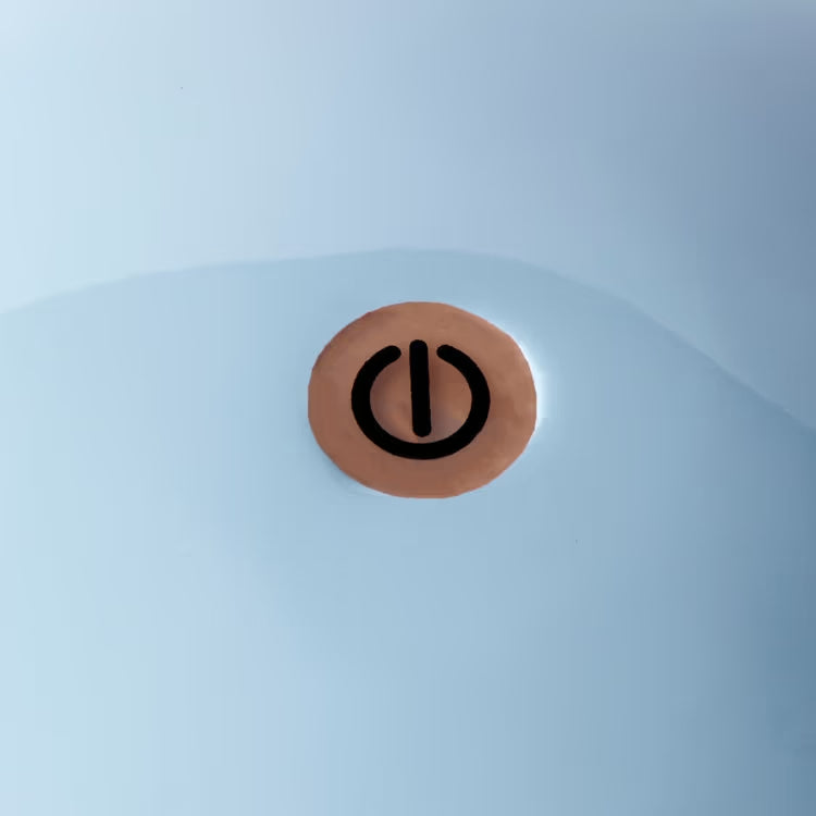 Close-up of the power button on the top of the pale blue lacquered lamp