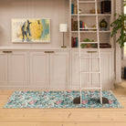 Lys Blue floral runner rug styled in a living room with wooden floors