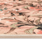 Close-up detail of the painterly floral brushwork and textured rug surface.