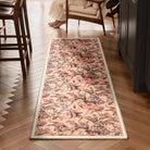 Lys Pink runner rug styled in a hallway on a wooden herringbone floor.