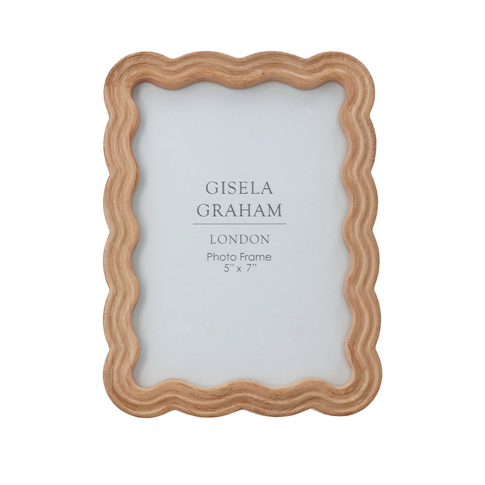 Natural brown wooden photo frame with a unique wavy scalloped edge design for five by seven inch photographs.