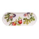 Overhead view of a rectangular white serving platter with botanical fig and pomegranate illustrations and scalloped edges
