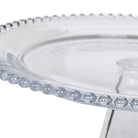 Close-up of the decorative beaded rim on the clear glass cake stand