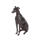 Three-quarter view of a sitting hound sculpture with a dark bronze-effect finish and alert ears.