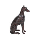 Side profile of a slender sitting dog ornament showing the textured finish and long neck.