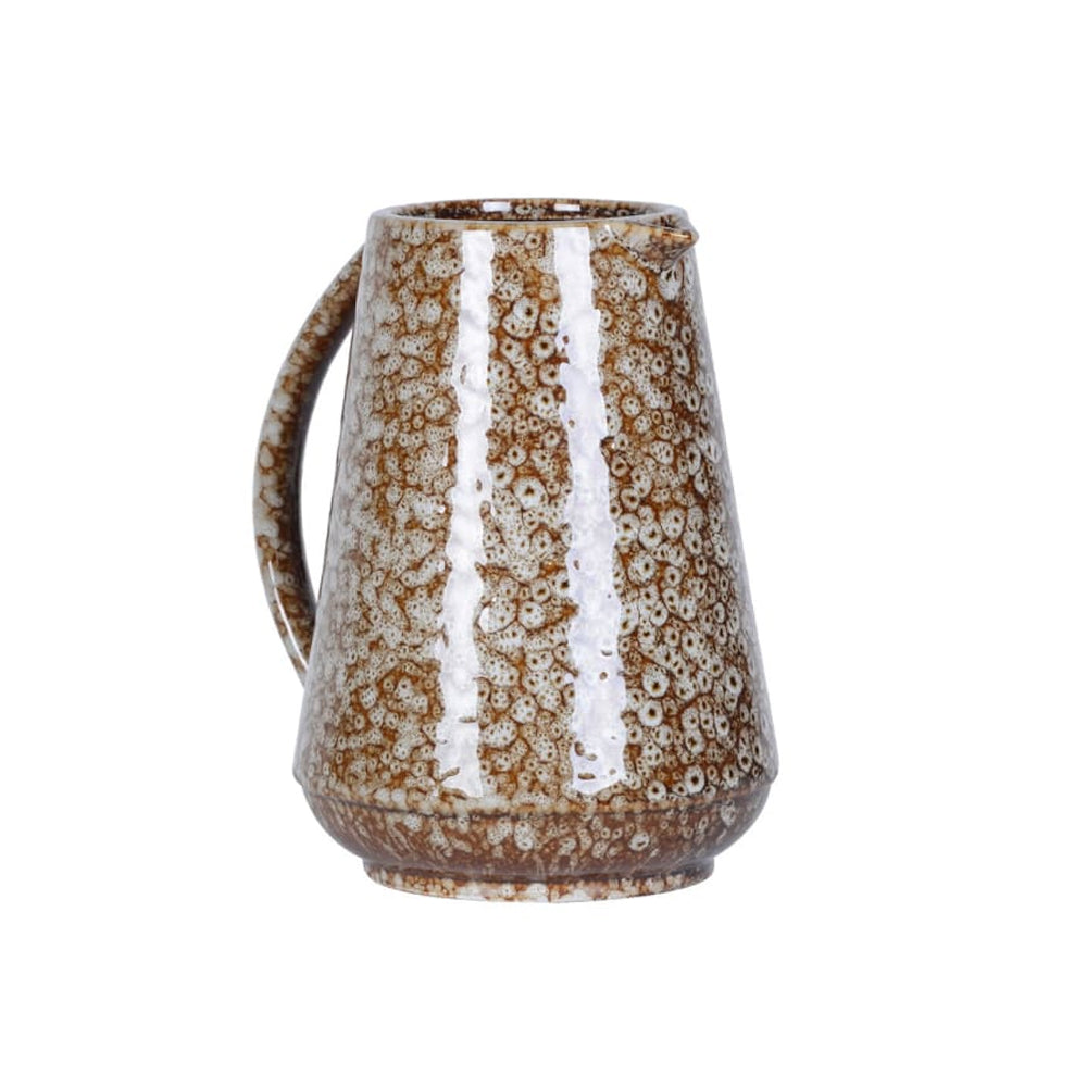 Stoneware jug with a brown and white speckled slip glaze finish against a plain background