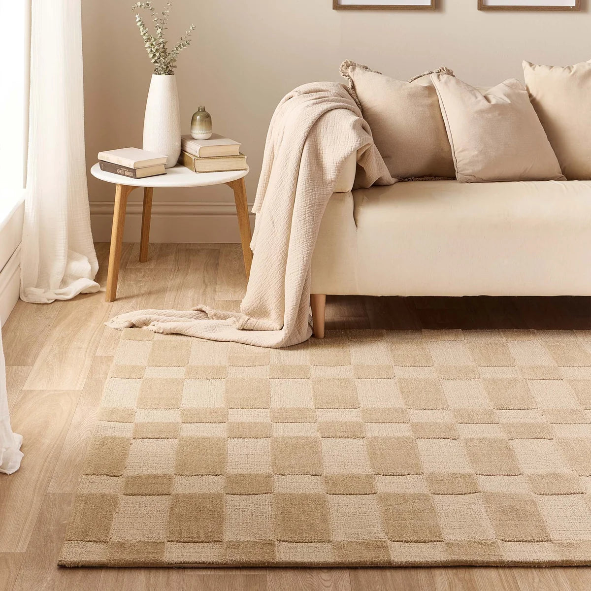 The Soho Beige rug in a living room context styled with a neutral fabric sofa and wooden coffee table.