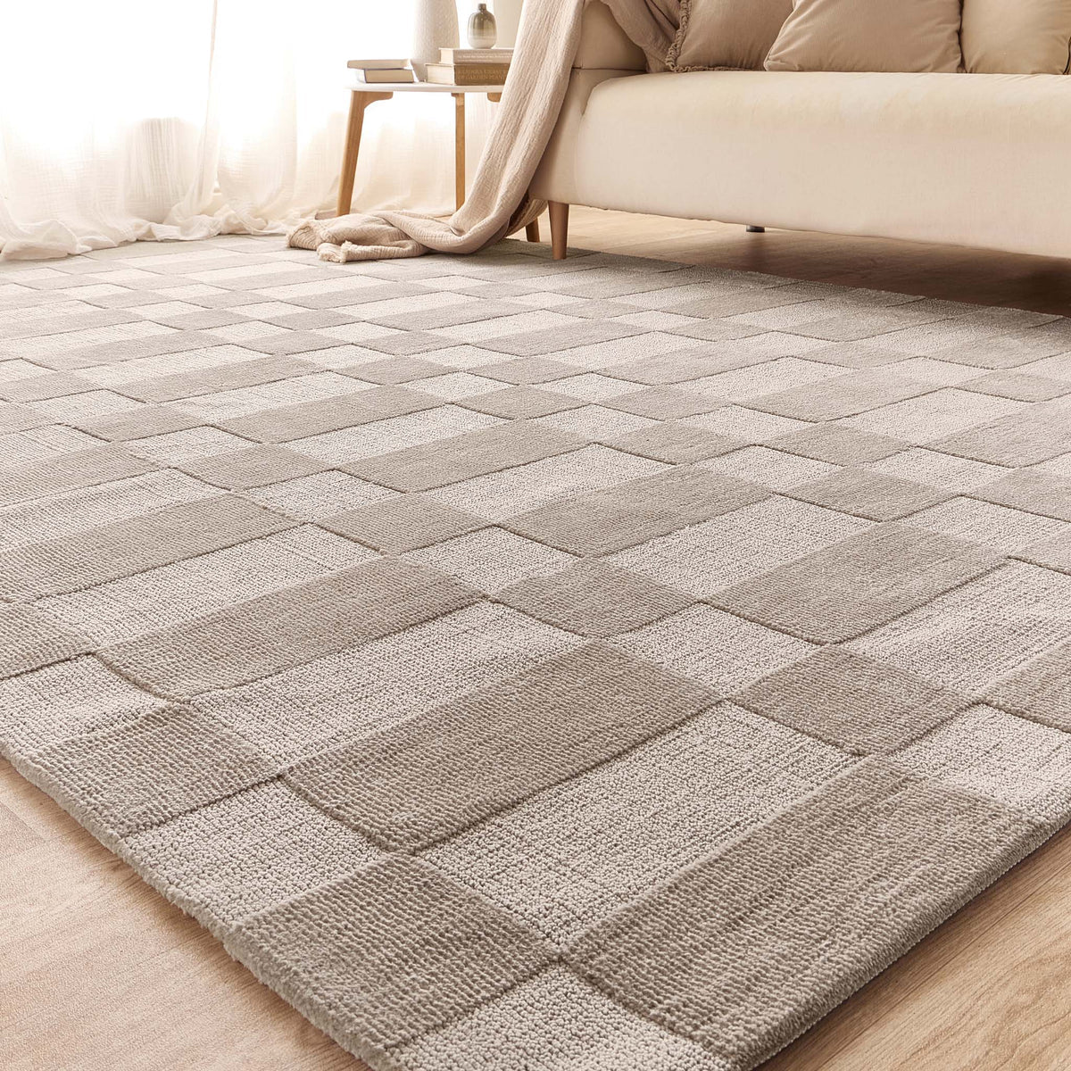 Angle view of the Soho rug in a living room setting showing the subtle two-tone pattern.