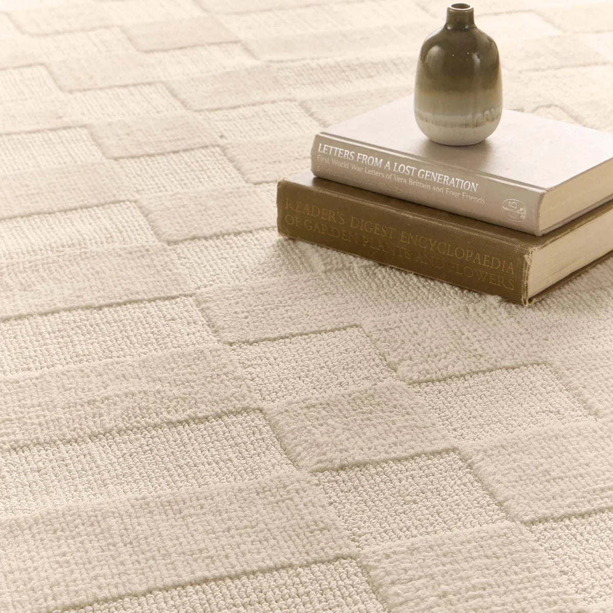 Close-up of the Soho Ivory Rug texture showing the tufted high pile and low loop pile heights.