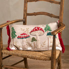 Embroidered toadstool cushion styled on a rustic wooden armchair with a rush seat.