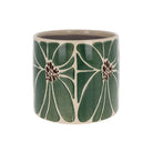 Green ceramic planter with a large white and dark brown petal pattern and a smooth glazed finish