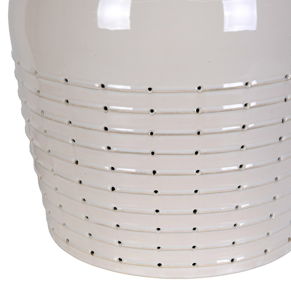 Close-up detail of the off-white ceramic lamp base showing the intricate pierced horizontal dotted pattern.