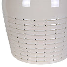 Close-up detail of the off-white ceramic lamp base showing the intricate pierced horizontal dotted pattern.