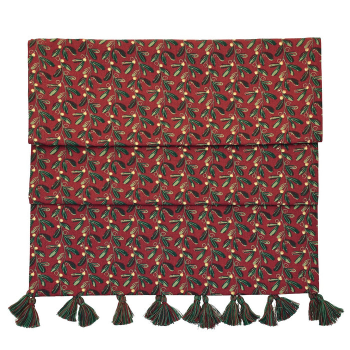 Under the Mistletoe table runner showing deep red print and decorative tassels against a white background.