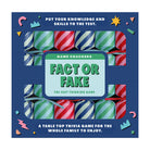 Fact or Fake trivia game crackers box with striped designs in blue, green, and red.