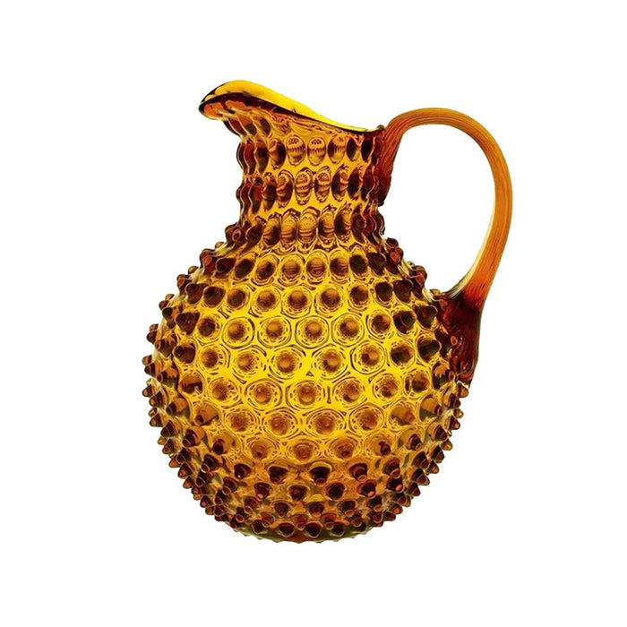 Amber yellow crystal glass jug with raised hobnail texture and tapered handle