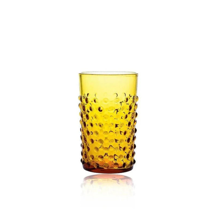 Amber yellow crystal tumbler with a textured hobnail design against a white background.