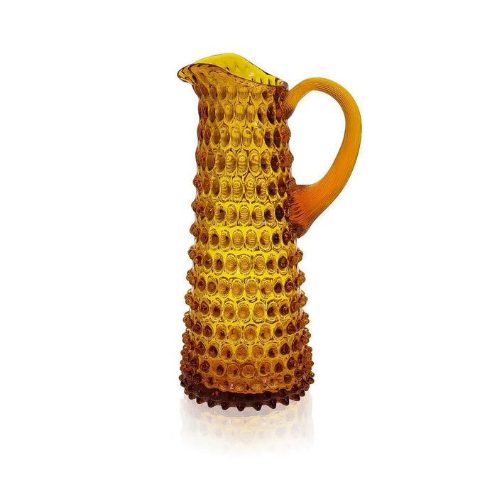 Amber tall hobnail jug in lead-free crystal with a tapered design and textured handle against a white background.