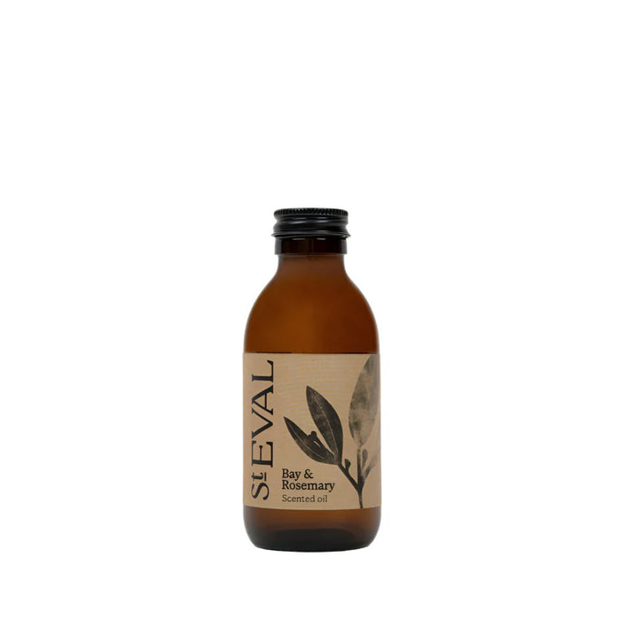 Amber glass diffuser refill bottle with a cream label featuring a bay leaf illustration
