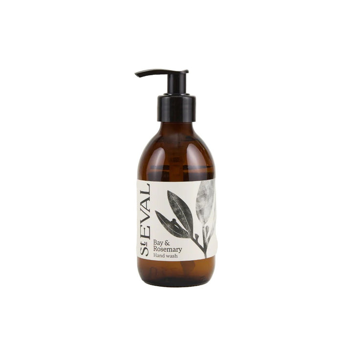 Amber glass bottle of Bay and Rosemary hand soap with a black pump dispenser