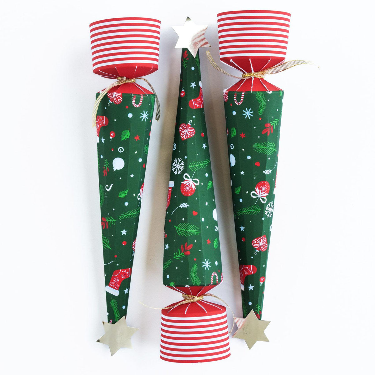 Close up of three upright Christmas tree crackers showing the festive green patterns and red striped bases.