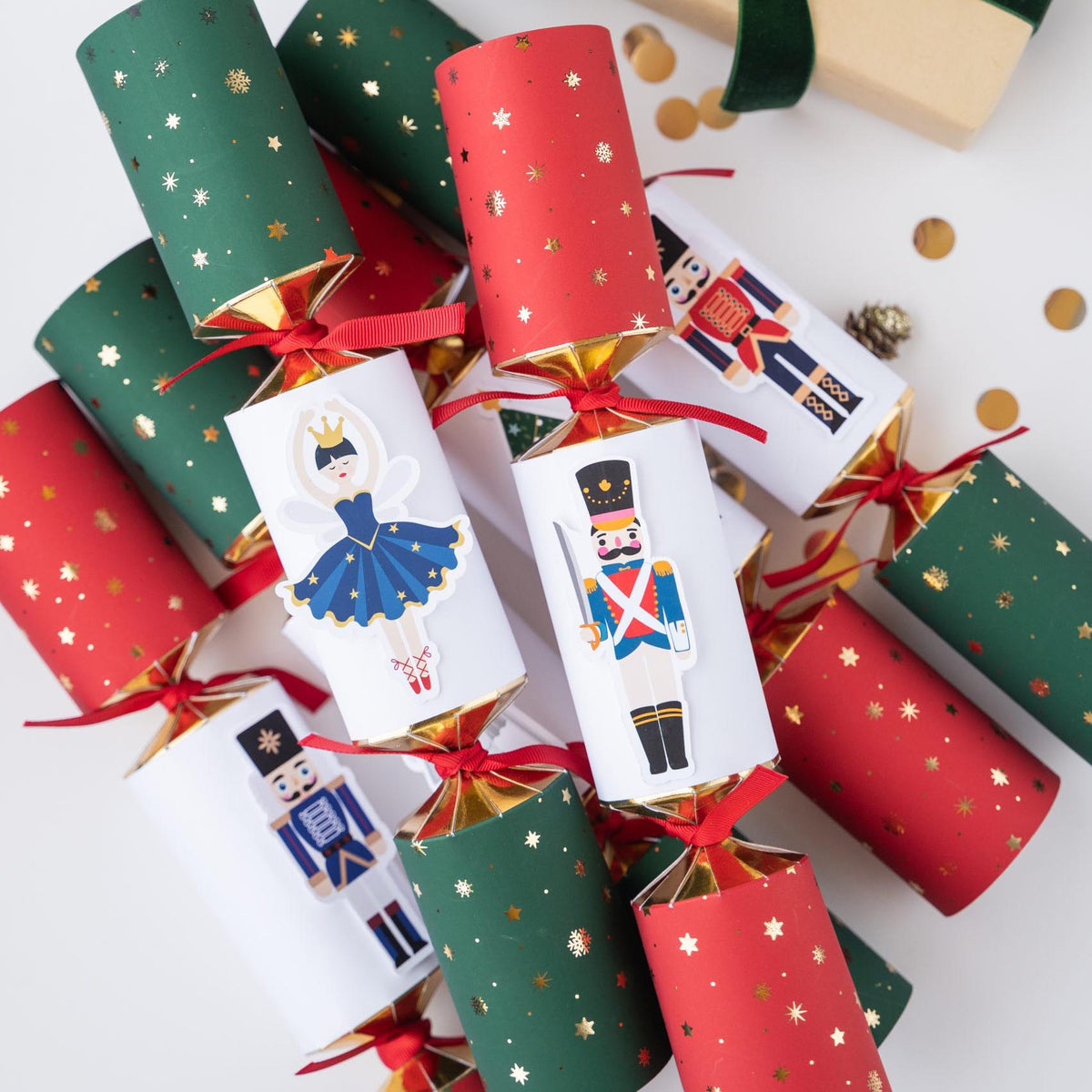 Arrangement of red and green Christmas crackers featuring Nutcracker characters and red ribbon bows.