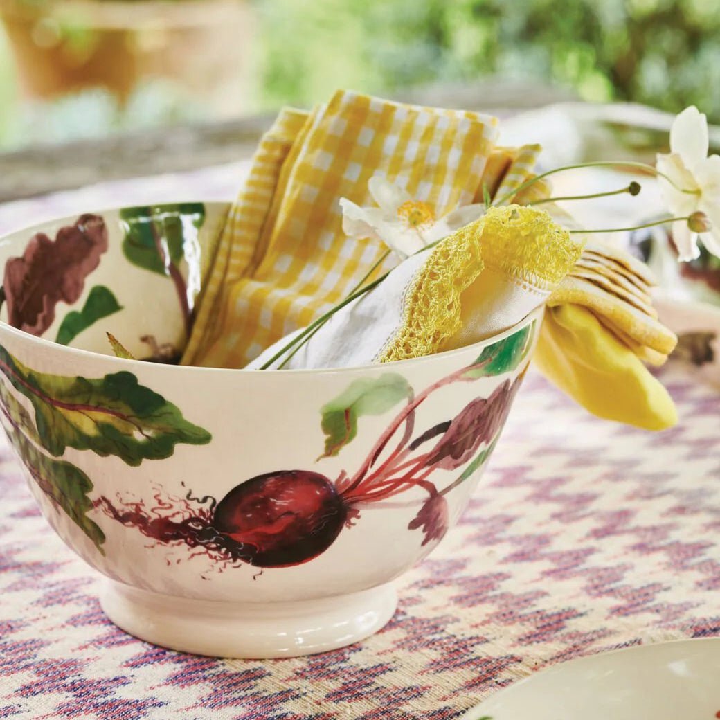 Lifestyle view of the Beetroot salad bowl styled with a yellow gingham napkin and spring flowers