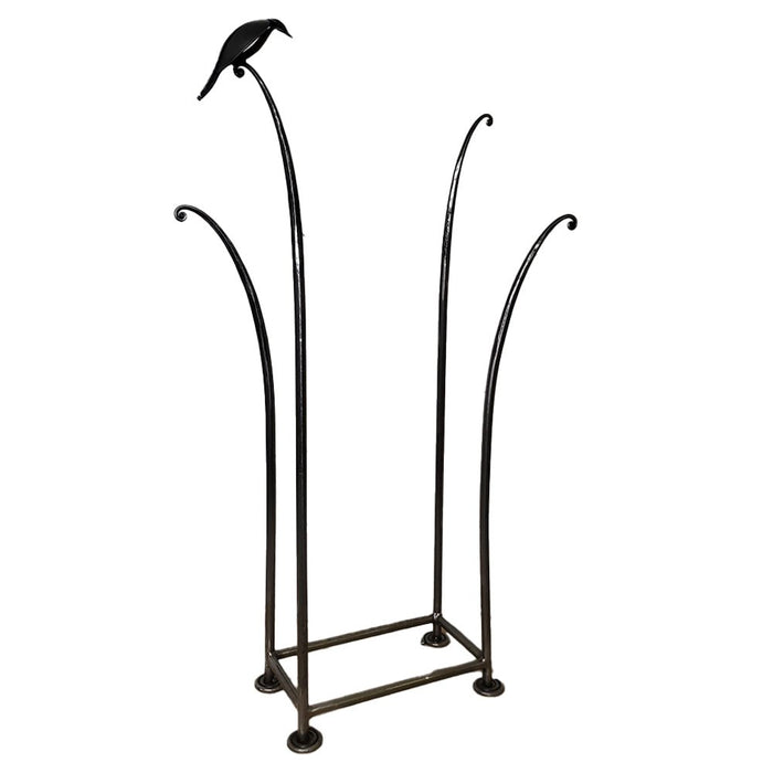 Angled view of the hand-forged wrought iron Bird Log Stack showing its tall vertical bars and bird detail.