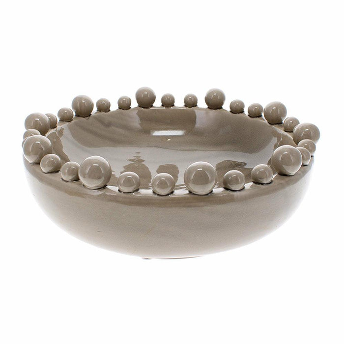 Grey ceramic bowl with variable sized spheres around the rim against a white background