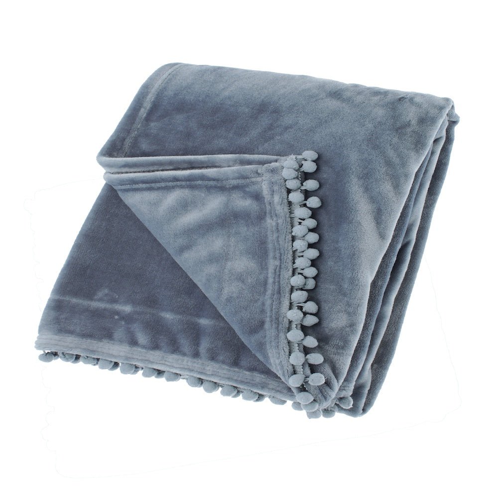 Folded smoke blue flannel fleece throw showing the soft texture and decorative pom-pom braid edge.