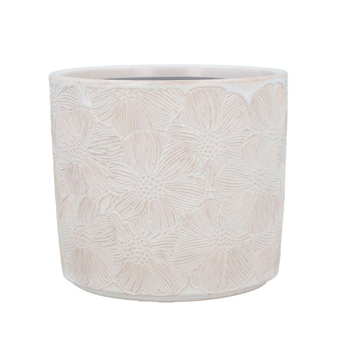 A soft white ceramic plant pot with embossed Cosmos flower patterns on a plain white background