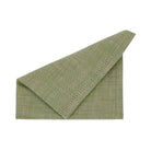 Olive green chambray cotton napkin folded to show the needled-out border detail and linen-like texture.