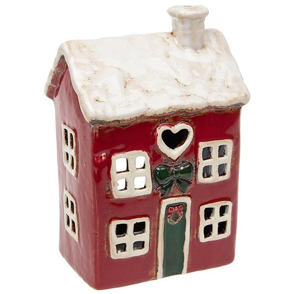 Red ceramic tea-light house with a white snowy roof, heart-shaped window, and green door detail.