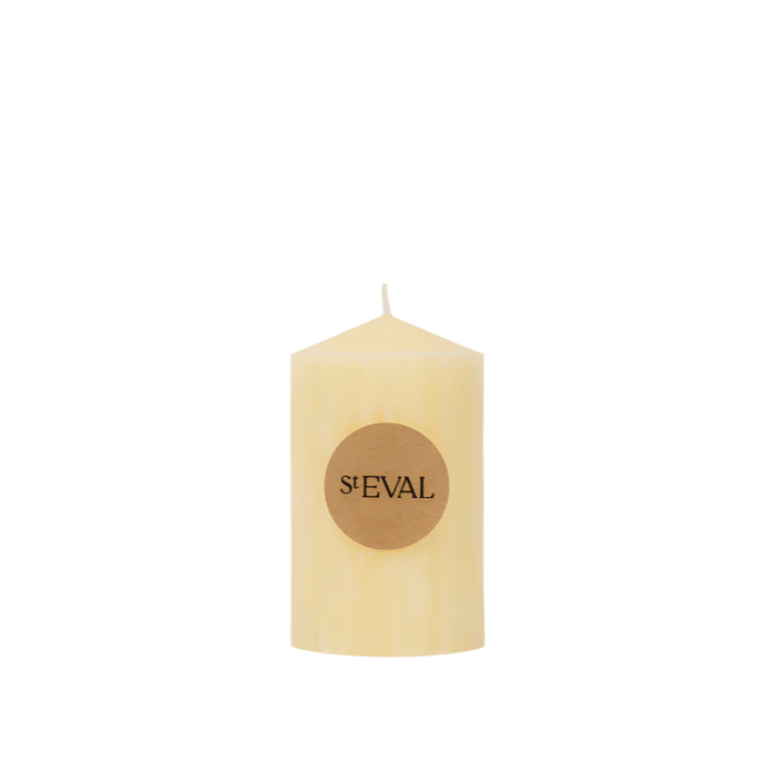 A single ivory church pillar candle with a small round logo label on a white background