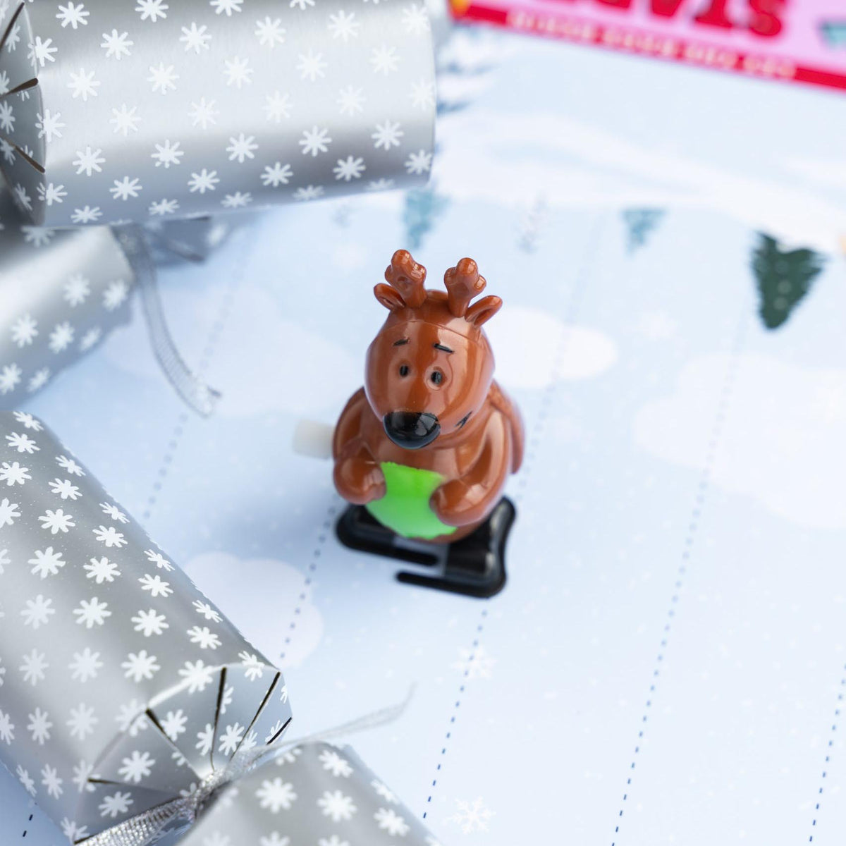 Close-up of a brown wind-up reindeer character on a winter-themed race track