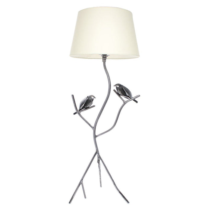 Hand-forged blackened metal table lamp with two bird motifs and a cream fabric shade