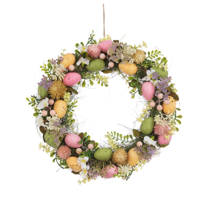 Easter wreath with pastel pink, green, and yellow speckled eggs and delicate faux spring flowers