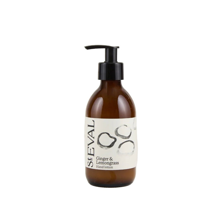 Ginger and lemongrass hand lotion in an amber glass bottle with a black pump dispenser