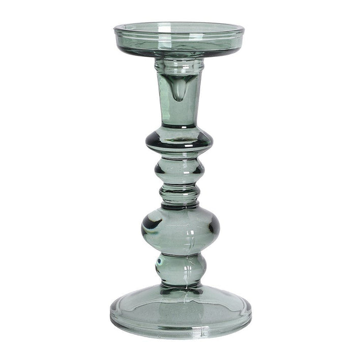 Green glass candlestick holder with a tiered contemporary silhouette and round base