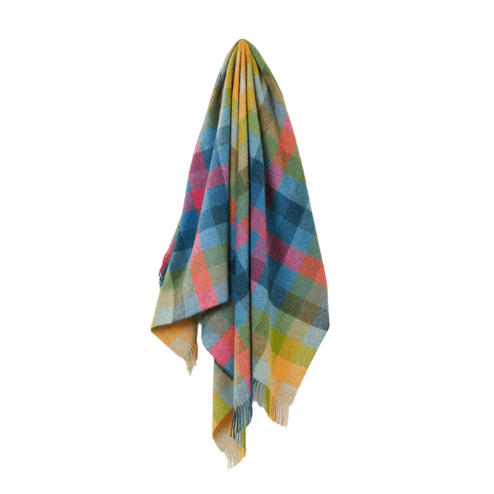 Vibrant multi-coloured check wool throw draped vertically against a white background