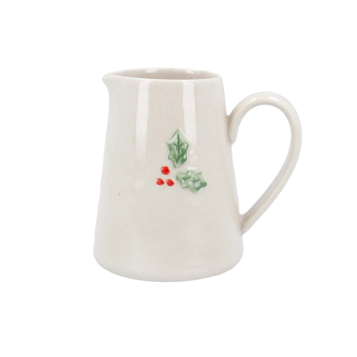Small cream ceramic jug with a green holly leaf and red berry motif on the side.